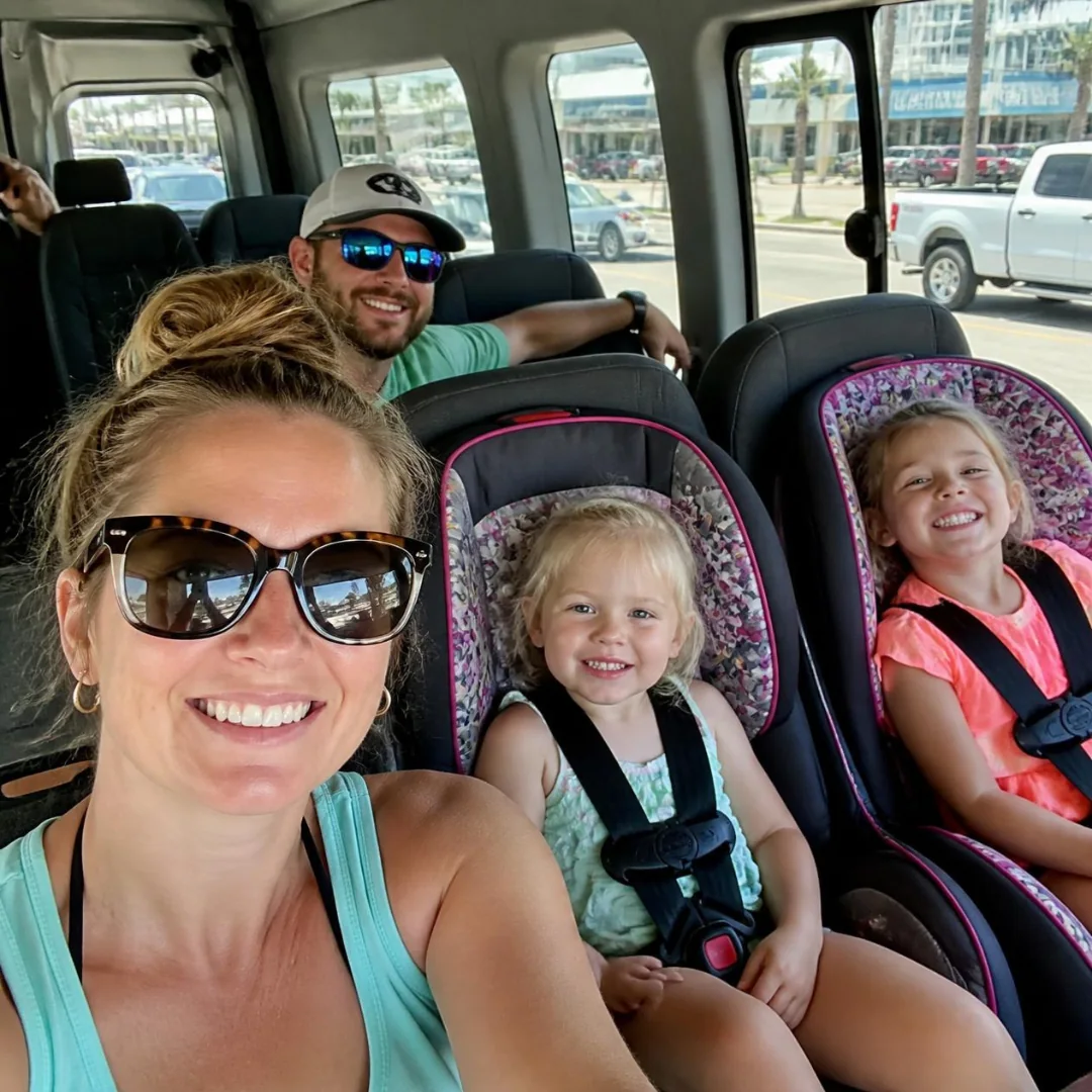 Toddler and booster car seats fitted in a Houston to Galveston Shuttle Co. van for a family cruise transfer
